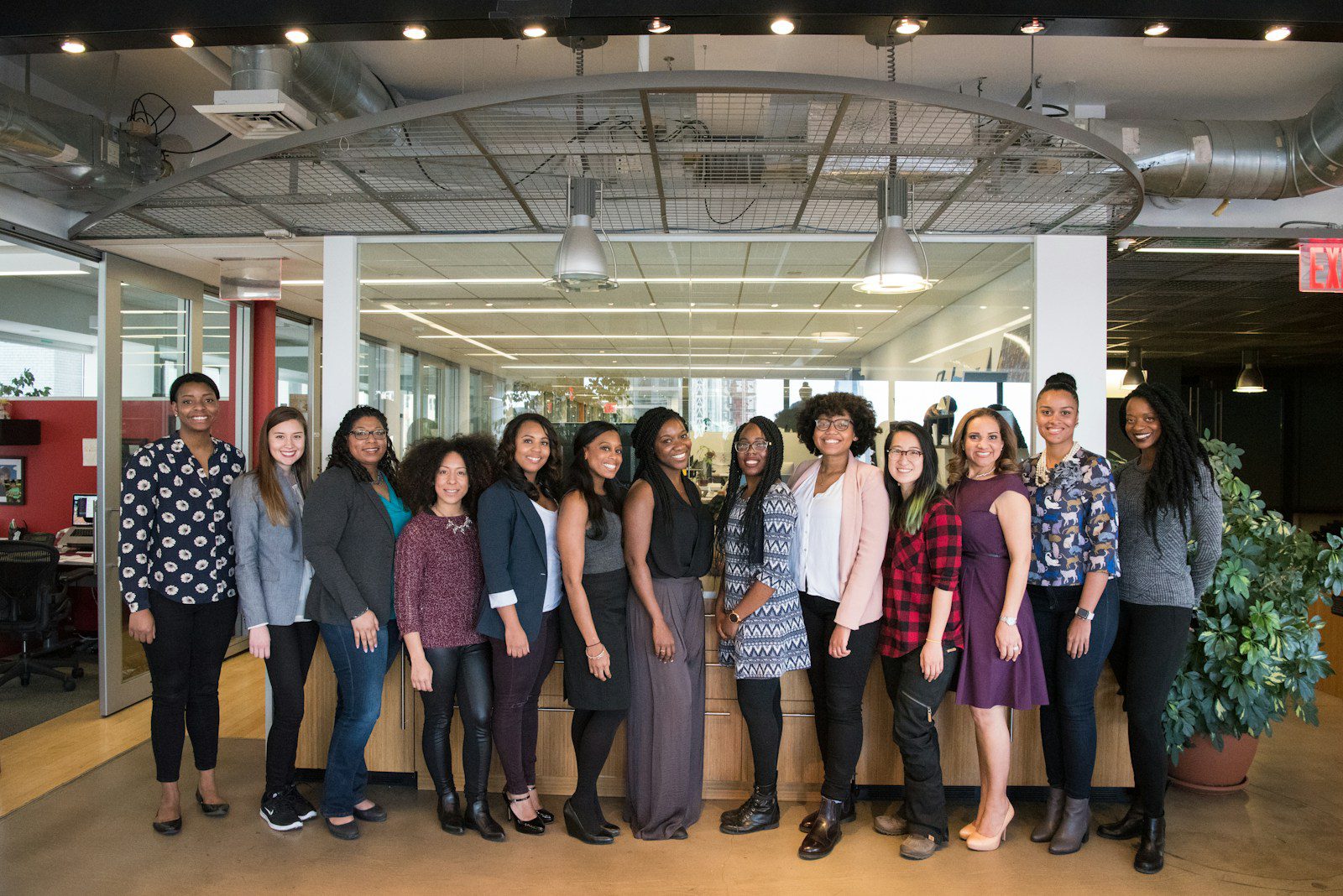 A group of people standing in an office.