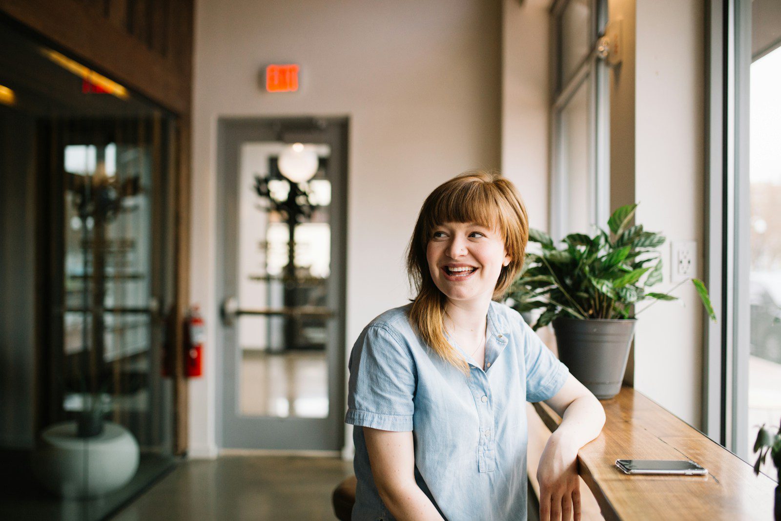 Photo by Brooke Cagle A woman smiling while standing in front of a door.