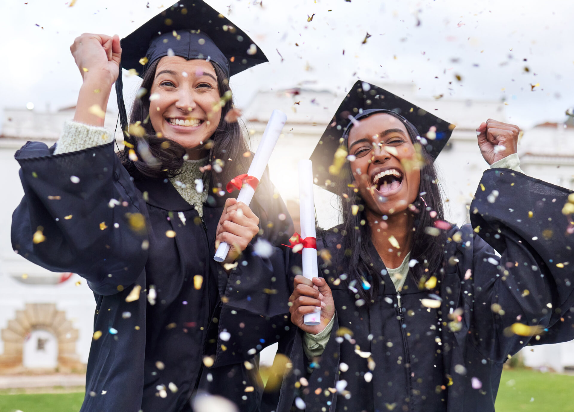 Cropped portrait of two attractive young female students celebrating on graduation day image of a happy man