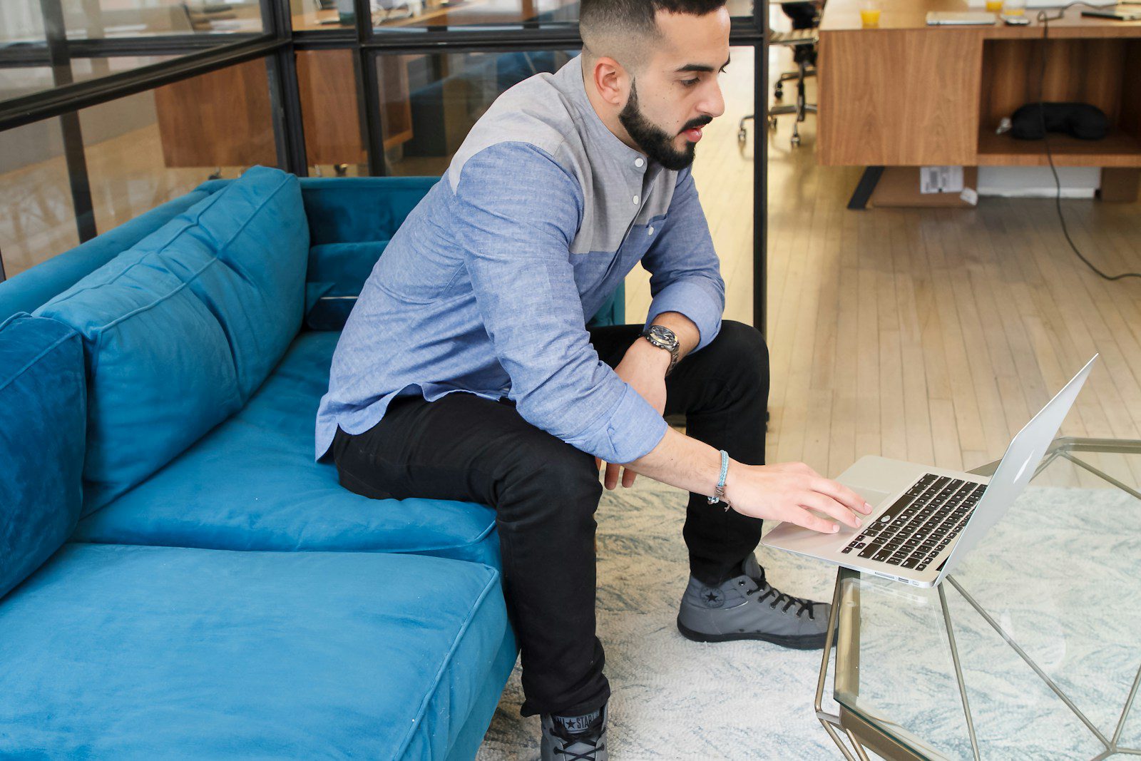 Photo by The Jopwell Collection a man sitting on a couch using a laptop computer